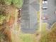 Aerial view of rooftops and numbered parking spaces next to lawn, mulch and bare trees at 2268 Plum Frost Dr, Raleigh, NC 27603