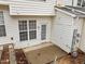 Exterior view featuring a back patio, white siding, windows, and access door, promoting outdoor living and entertaining at 2268 Plum Frost Dr, Raleigh, NC 27603