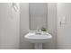Charming powder room features a pedestal sink, decorative mirror, and neutral wall paint at 2268 Plum Frost Dr, Raleigh, NC 27603
