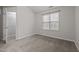 Bright bedroom has neutral carpet, a closet, and a window providing natural light at 2268 Plum Frost Dr, Raleigh, NC 27603