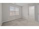 Carpeted bedroom showcasing an open closet and natural light from window at 2268 Plum Frost Dr, Raleigh, NC 27603