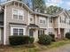 Inviting townhouse with beautiful landscaping, a blue front door, and neutral siding at 2268 Plum Frost Dr, Raleigh, NC 27603