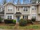 Inviting townhouse with beautiful landscaping, a blue front door, and neutral siding at 2268 Plum Frost Dr, Raleigh, NC 27603