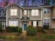 Inviting townhouse with beautiful landscaping, a blue front door, and neutral siding at 2268 Plum Frost Dr, Raleigh, NC 27603