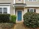 The front of this home has a blue door, established shrubbery, and a well-maintained lawn at 2268 Plum Frost Dr, Raleigh, NC 27603
