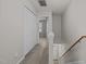 Upstairs hallway featuring neutral walls and carpet, as well as a wooden handrail at 2268 Plum Frost Dr, Raleigh, NC 27603