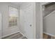 Hallway featuring natural light from window and door leading to stairs at 2268 Plum Frost Dr, Raleigh, NC 27603
