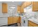 Bright kitchen with wood cabinets, laminate floors and decorative archway at 2268 Plum Frost Dr, Raleigh, NC 27603