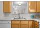 Kitchen showcasing stainless steel sink and countertop and wood cabinetry at 2268 Plum Frost Dr, Raleigh, NC 27603
