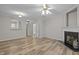 The living room features a fireplace, neutral walls, hardwood floors, and is adjacent to other rooms at 2268 Plum Frost Dr, Raleigh, NC 27603