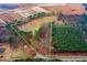 Expansive aerial view of property lines showcasing land, trees, and nearby road at 2502 Devils Racetrack Rd, Four Oaks, NC 27524