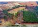 An aerial shot reveals a home nestled among trees, with a construction site nearby at 2502 Devils Racetrack Rd, Four Oaks, NC 27524