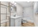 Bright bathroom features a white vanity, framed mirror, open shelving and a shower-tub combination at 2502 Devils Racetrack Rd, Four Oaks, NC 27524
