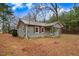 Home exterior features include tidy landscaping, natural light, and inviting curb appeal at 2502 Devils Racetrack Rd, Four Oaks, NC 27524