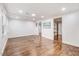 Spacious living room boasts wood floors and natural light, enhanced by multiple doorways and modern lighting at 2502 Devils Racetrack Rd, Four Oaks, NC 27524