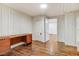 Office space with hardwood floors, wood paneling, and a clean design creates a professional and comfortable workspace at 2502 Devils Racetrack Rd, Four Oaks, NC 27524
