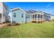 A home's light teal back exterior features a screened-in porch and a freshly sodded yard at 264 Big Bradley Dr, Wendell, NC 27591