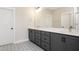 Bathroom with double sink vanity, quartz counters, and decorative tile floor at 264 Big Bradley Dr, Wendell, NC 27591