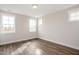 Bright bedroom with wood floors and multiple windows offering natural light at 264 Big Bradley Dr, Wendell, NC 27591