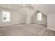 Bonus room with neutral carpet, lots of light, and angled ceilings at 264 Big Bradley Dr, Wendell, NC 27591