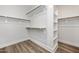 Spacious walk-in closet with custom shelving and wood closet rods at 264 Big Bradley Dr, Wendell, NC 27591