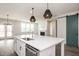 Open-concept kitchen with a large island, stainless steel appliances, and a cozy fireplace nearby at 264 Big Bradley Dr, Wendell, NC 27591