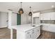 Modern kitchen with stainless steel appliances, pendant lighting, and a sliding barn door at 264 Big Bradley Dr, Wendell, NC 27591