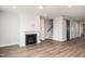 Spacious living room featuring a fireplace, staircase, and modern barn door at 264 Big Bradley Dr, Wendell, NC 27591