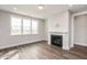Bright living room with a fireplace, large windows, and stylish flooring at 264 Big Bradley Dr, Wendell, NC 27591