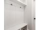 Bright mudroom with a built in bench, coat hooks and extra storage above at 264 Big Bradley Dr, Wendell, NC 27591