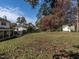 Spacious backyard with mature trees, a storage shed, and a lush lawn, perfect for outdoor activities at 304 Northbrook Dr, Raleigh, NC 27609