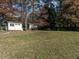 Backyard with a shed, mature trees, and a well-maintained lawn, ideal for recreation and relaxation at 304 Northbrook Dr, Raleigh, NC 27609
