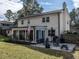 Back exterior view showing a brick patio with outdoor seating, a grill, and a well-maintained lawn at 304 Northbrook Dr, Raleigh, NC 27609