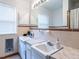 Bathroom with double sink vanity, large mirror, and retro ceramic tile at 304 Northbrook Dr, Raleigh, NC 27609