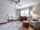 Bright Bedroom features hardwood floors, two cribs, a plush armchair and plenty of sunlight at 304 Northbrook Dr, Raleigh, NC 27609