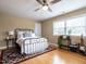 Cozy bedroom with wood floors, a metal bed frame, and a large window for ample natural light at 304 Northbrook Dr, Raleigh, NC 27609