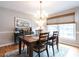 Dining room with hardwood floors, elegant light fixture, and natural light at 304 Northbrook Dr, Raleigh, NC 27609