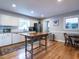 Spacious kitchen featuring white cabinets, stainless steel appliances, hardwood floors, and center island at 304 Northbrook Dr, Raleigh, NC 27609