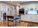 Bright kitchen featuring white cabinetry, stainless steel appliances, hardwood floors, and central island at 304 Northbrook Dr, Raleigh, NC 27609