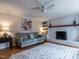 Comfortable living room showcasing a painted brick fireplace, a plush grey sofa, and light-filled interiors at 304 Northbrook Dr, Raleigh, NC 27609