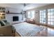 Cozy living room with painted brick fireplace, built-in shelves, french doors, and bright natural light at 304 Northbrook Dr, Raleigh, NC 27609