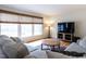 Bright living room with large windows, wood floors, a large TV, and neutral-toned sofas at 304 Northbrook Dr, Raleigh, NC 27609