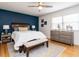 Serene main bedroom features a navy accent wall, wood flooring, and ample natural light at 304 Northbrook Dr, Raleigh, NC 27609