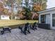 Brick patio featuring outdoor seating and view of the backyard with a storage shed and mature trees at 304 Northbrook Dr, Raleigh, NC 27609