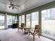 Enclosed sunroom with sliding glass doors providing a view of the backyard at 304 Northbrook Dr, Raleigh, NC 27609