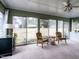 Bright sunroom featuring sliding glass doors and comfortable seating area with natural light at 304 Northbrook Dr, Raleigh, NC 27609