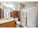 Bathroom with shower, toilet, sink, mirror, and brown tile at 309 Malvern Hill Ln, Morrisville, NC 27560