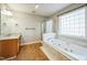 Bathroom with a large tub, shower, and double sink vanity at 309 Malvern Hill Ln, Morrisville, NC 27560