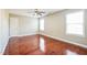 Bedroom with hardwood floors, a ceiling fan, and two windows at 309 Malvern Hill Ln, Morrisville, NC 27560