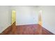 Spacious bedroom features gleaming hardwood floors, white walls and trim and ample doorways at 309 Malvern Hill Ln, Morrisville, NC 27560